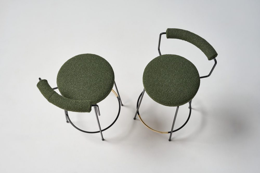 Iva swivel stools with green boucle upholstery and texture black pc legs and brass footrail