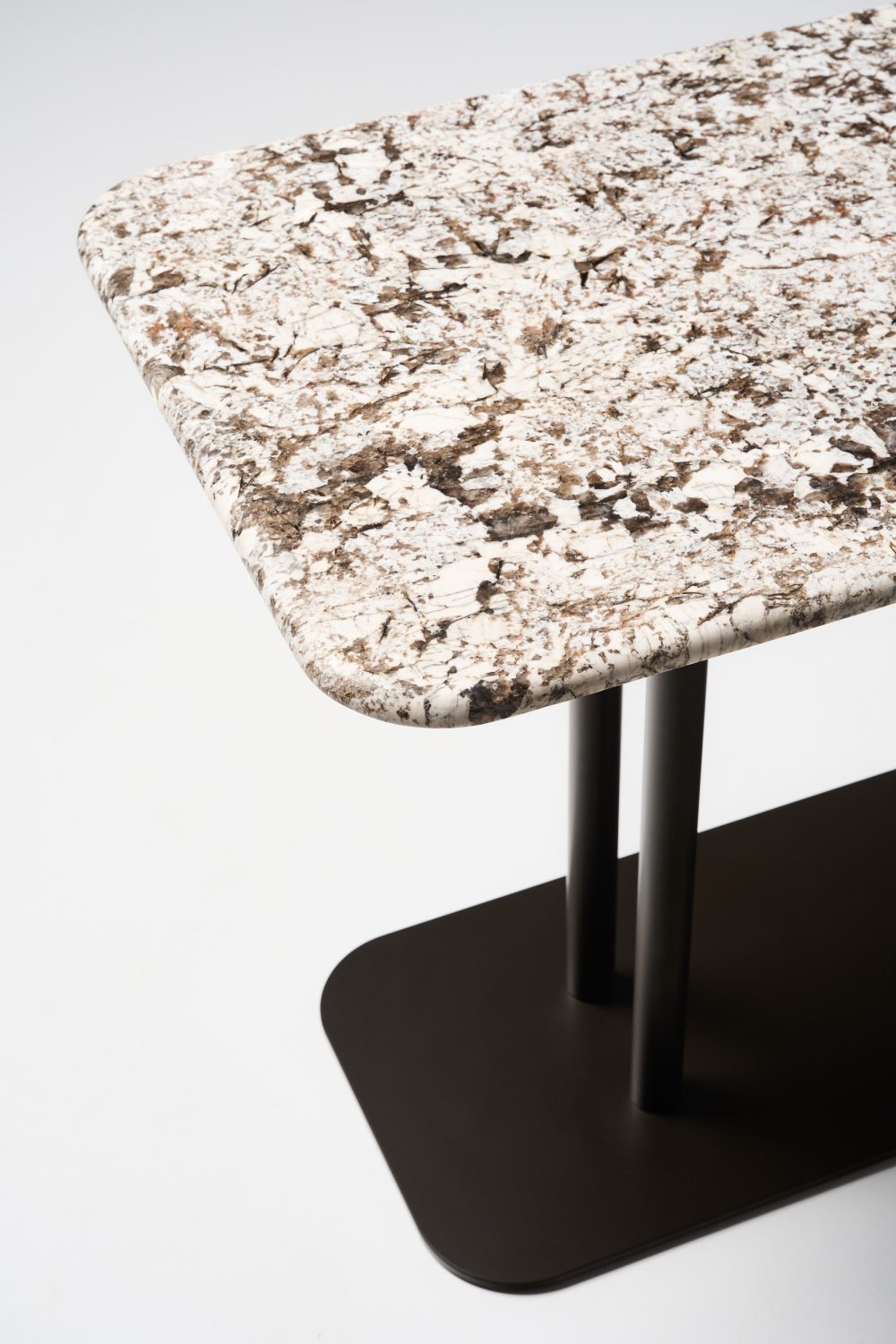 detail Pillar rectangular table 1400l x 900h with luna stone top and dark bronze pc legs